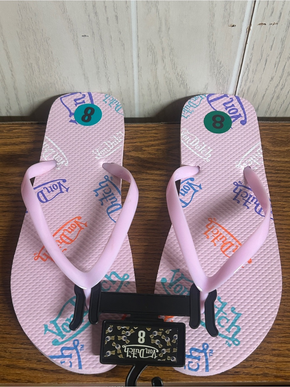 NWT Von Dutch flip-flops featuring a repeating multicolor logo print size 8